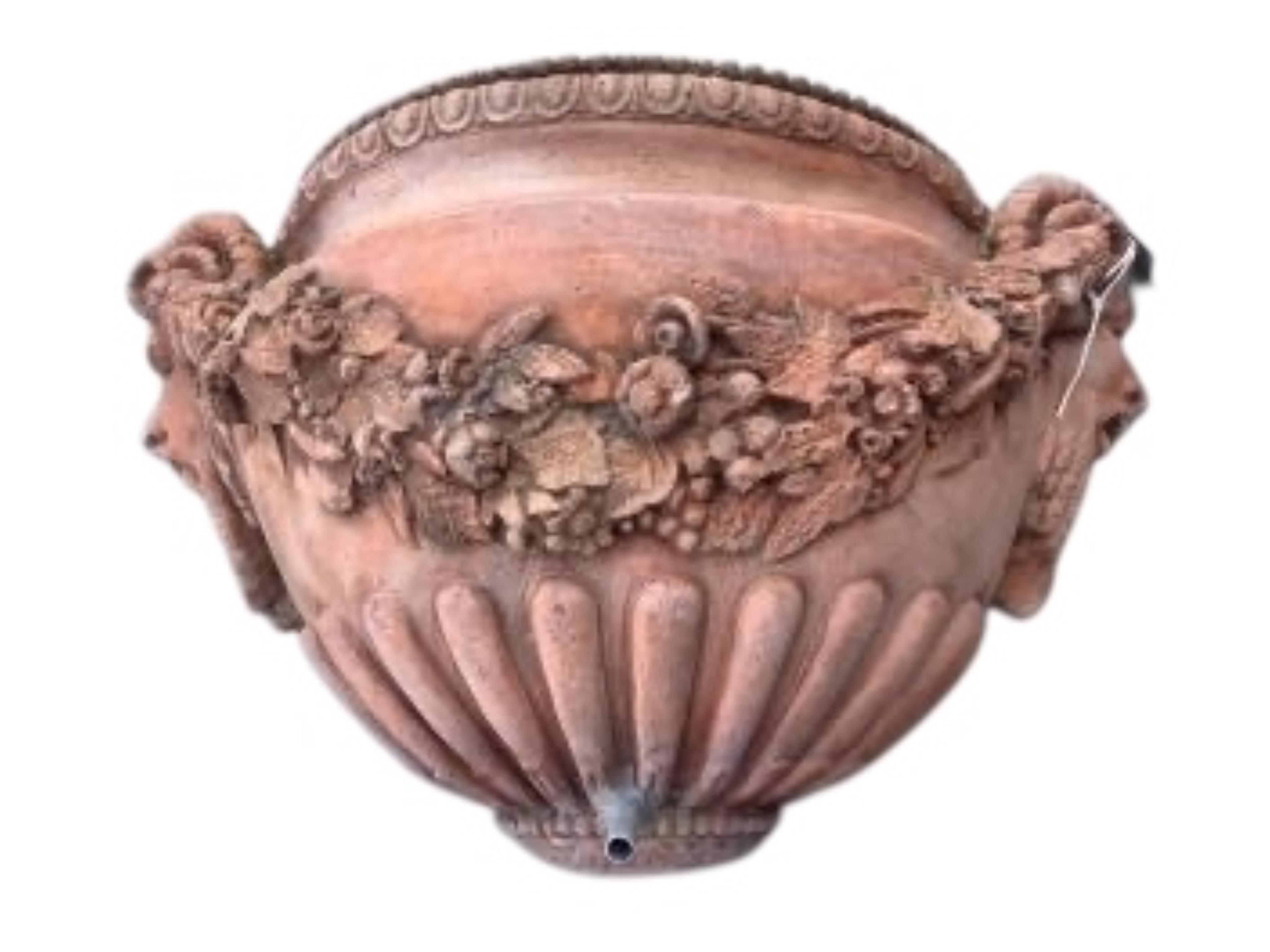 A pair of terracotta wall pocket garden fountains, width 46cm, depth 16cm, height 27cm